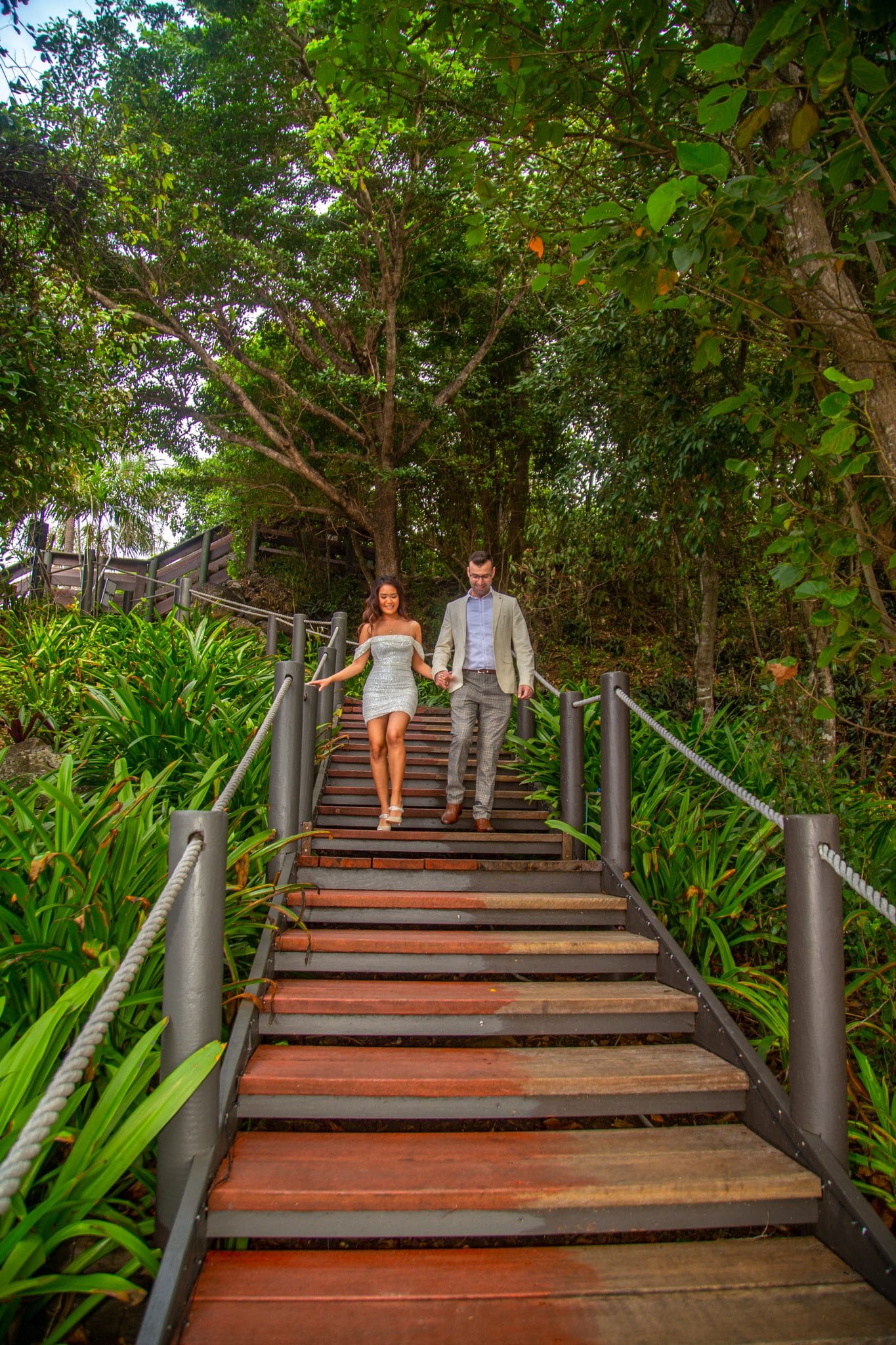 2 people walking down a set of stairs