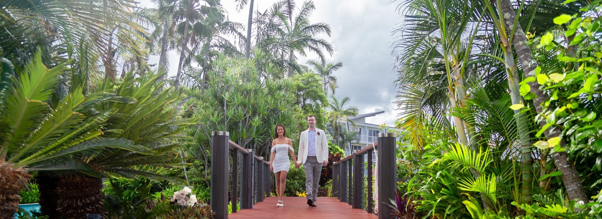 2 people walking over a bridge
