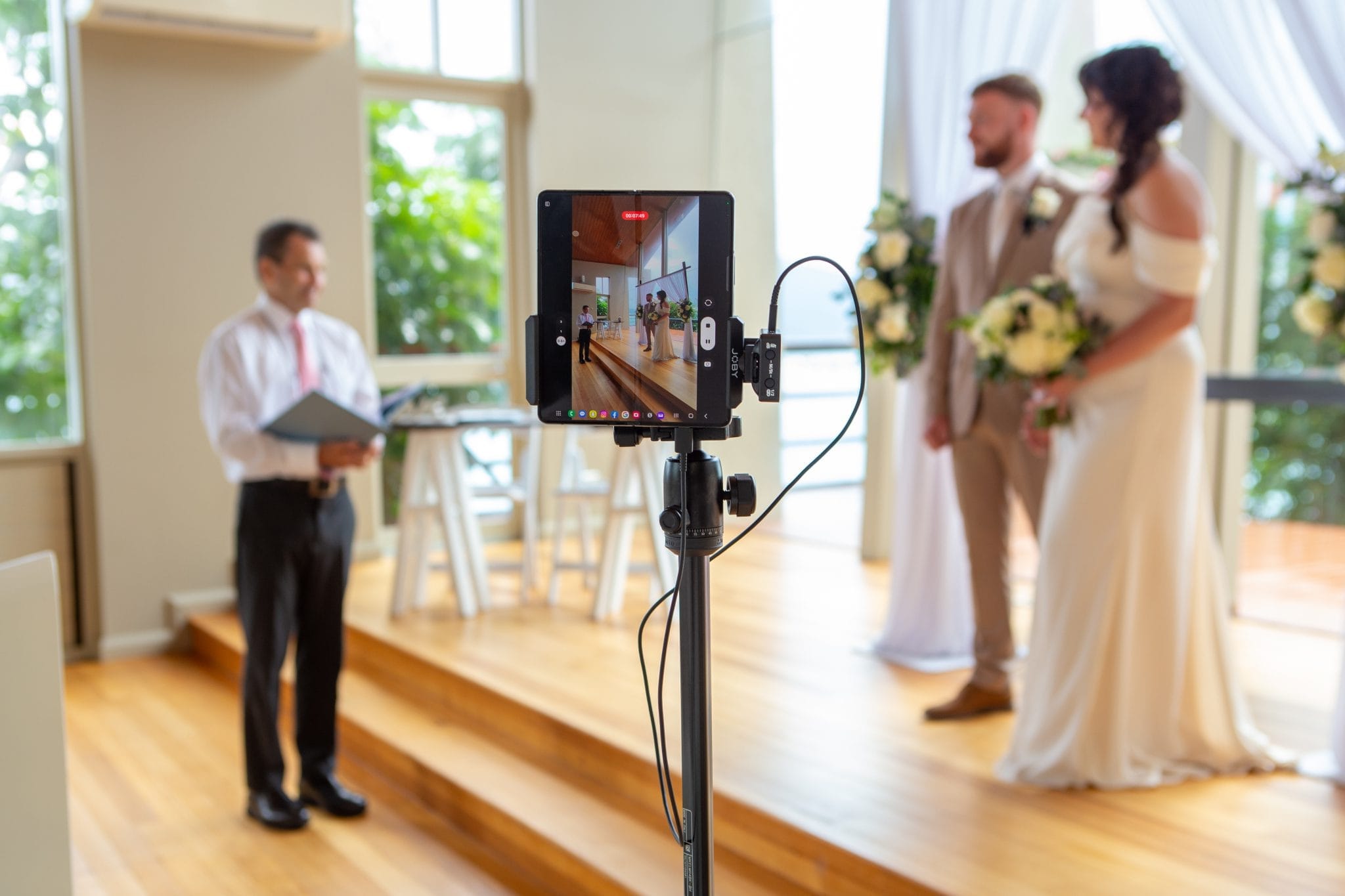 Bride and groom with a tablet recording