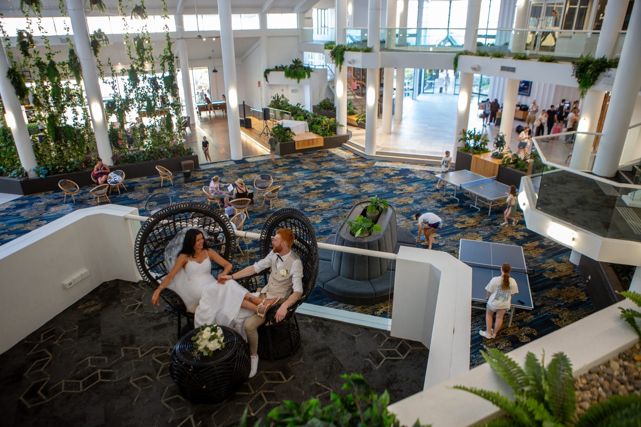 Bride and groom relaxing on a balcony inside a hotel