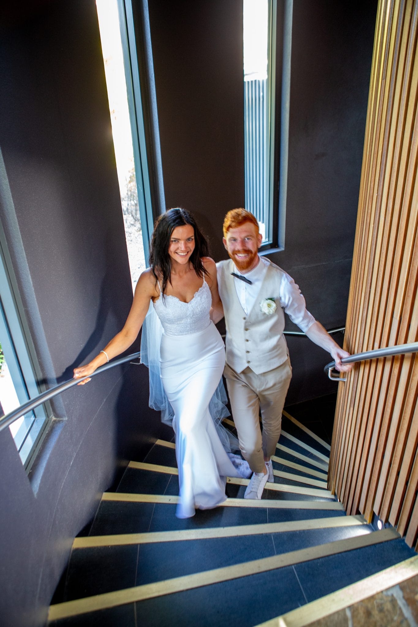 Bride and groom walking up a staircase